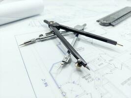 Paper home floor plan with compass. Architectural sketching process concept. Floor plan on architect's desk. photo