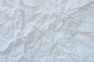 Wrinkled or crumpled white stencil paper or tissue after use in toilet or restroom with large copy space used for background texture in decorative art work photo