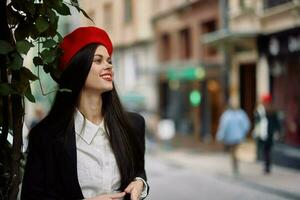 Girl smile with teeth stands on the street in the city in a jacket and red beret, cinematic french style photo