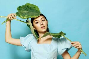 studio woman cosmetic palm young leaf smile sweet beauty blue pink photo