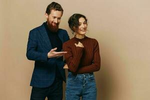 Man and woman couple in a relationship smile and interaction on a beige background in a real relationship between people photo