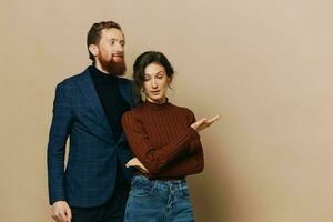 Man and woman couple in a relationship smile and interaction on a beige background in a real relationship between people photo