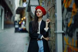 Fashion woman portrait walking tourist in stylish clothes with red lips walking down narrow city street, travel, cinematic color, retro vintage style, dramatic. photo