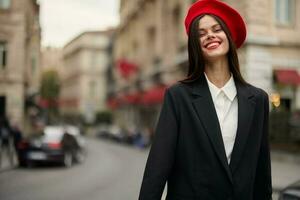 Fashion woman portrait smile teeth standing on the street in the city background in stylish clothes with red lips and red beret, travel, cinematic color, retro vintage style, urban fashion lifestyle. photo