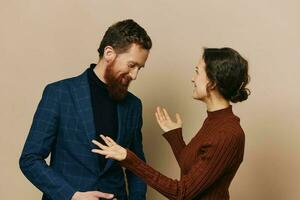 Man and woman couple in a relationship smile and interaction on a beige background in a real relationship between people photo