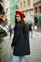 Woman smile fashion model walks on the street in the city center among the crowd in a jacket and red beret and jeans, cinematic french fashion style clothing, travel to istanbul spring photo