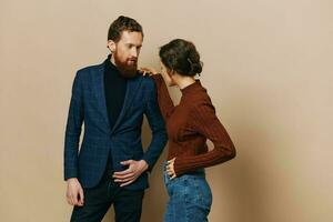 Man and woman couple in a relationship smile and interaction on a beige background in a real relationship between people photo