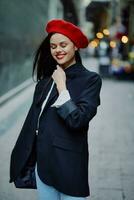 Fashion woman smile with teeth portrait walking tourist in stylish clothes in jacket with red lips walking down narrow city street flying hair, travel, cinematic color, retro vintage style. photo