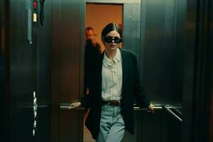 Stylish woman in black jacket and sunglasses posing in elevator, fashion model, dark cinematic light and color, glamor vintage photo