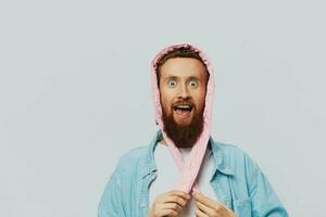 Funny man in a pink hat portrait on a light gray background. Smile and positive emotions. photo