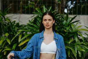 Portrait of a woman against a backdrop of palm trees in the tropics, summer vacations and holidays photo