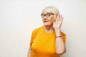 Photo of retired old lady in casual t-shirt and glasses close-up