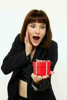 beautiful woman with gift small box in a leather suit black jacket isolated background photo