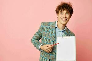 Young curly-haired man in a business suit copy-space documents isolated background unaltered photo