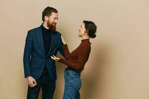 Man and woman couple in a relationship smile and interaction on a beige background in a real relationship between people photo