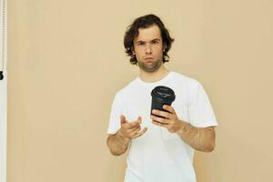 Cheerful man with a black glass in a white t-shirt isolated background photo