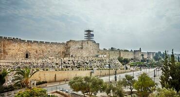 Outer wall of the old city in Jerusalem, overlooking the Tower of David and the road photo