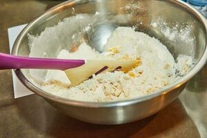 Dough in a bowl for making a pie photo