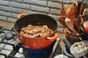 Sizzling Home-Cooked Beef Juicy cuts seared to perfection on a gas stove in a cozy kitchen photo