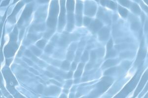 Blue water with ripples on the surface. Defocus blurred transparent blue colored clear calm water surface texture with splashes and bubbles. Water waves with shining pattern texture background. photo