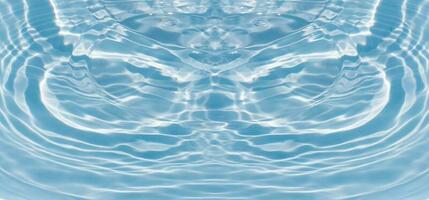 Blue water with ripples on the surface. Defocus blurred transparent blue colored clear calm water surface texture with splashes and bubbles. Water waves with shining pattern texture background. photo