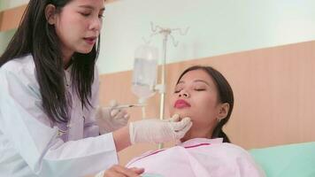 Asian female cosmetic doctor inject Botox into face of woman patient, face care, skin treatment, and young aging with body skincare at beauty clinic hospital, and cosmology medical. video