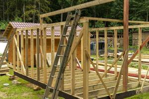 construction of a frame house. Timber frame house, new build roof photo