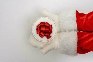 Santa's hands are holding a gift for Christmas. white background photo