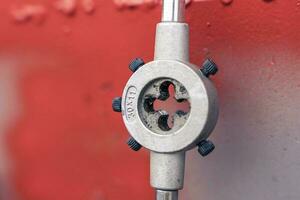 a die for threading on a shelf in the workshop photo