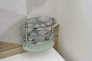 shiny toothbrush holder in the bathroom interior. bathroom accessories photo