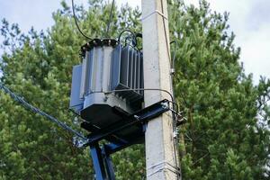 network transformer installed and fixed on a reinforced concrete pole photo