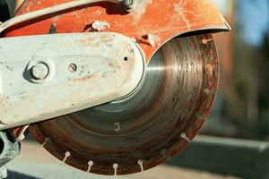 close-up of a saw with a disc for cutting concrete and paving slabs photo