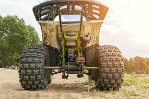 Rear view of the ATV standing on sandy ground photo