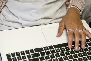 beautiful female hands are typing on a laptop.Remote work on computer photo