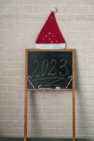 a black slate on which the year 2023 is written in chalk. Happy New Year. photo