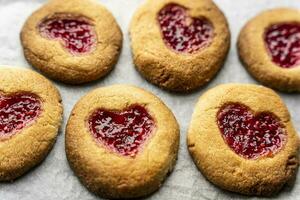 Homemade cookies decorated with raspberry jam in the shape of a heart photo