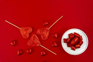 gift box with a ribbon and a bow, heart-shaped chocolates photo