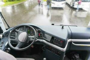 view of the dashboard and steering wheel of a tourist bus photo