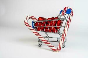 A supermarket trolley loaded with candies and Christmas caramel canes photo