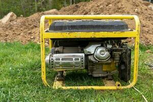 portable gasoline generator operating on a construction site photo