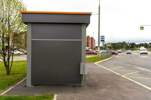 an empty bus stop in the city with a place for advertising photo