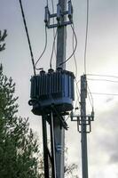 network transformer installed and fixed on a reinforced concrete pole photo