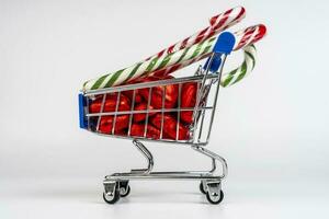 A supermarket trolley loaded with candies and Christmas caramel canes photo