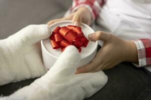 Santa gives a Christmas gift to a child photo