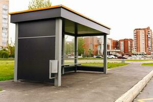 empty metal and glass bus stop in the city with place for advertising photo