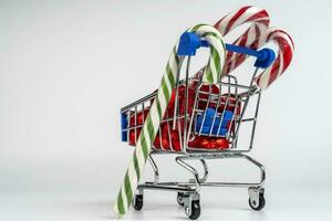 A supermarket trolley loaded with candies and Christmas caramel canes photo