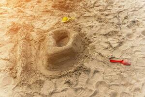 sand castle on the beach. a castle built by a child out of raw sand photo