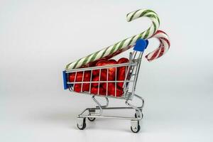 A supermarket trolley loaded with candies and Christmas caramel canes photo