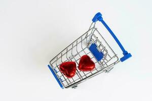Supermarket trolley loaded with heart shaped candies photo