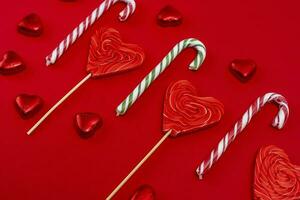 red festive Christmas background with candy in the shape of hearts photo